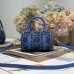 Close-up of replica Dior metal 'D' charm