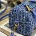 Model carrying replica Dior crossbody in urban setting