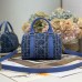 Close-up of replica Dior metal 'D' charm