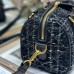 Model carrying replica Dior crossbody in urban setting