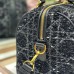 Close-up of replica Dior metal 'D' charm