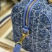 Model carrying replica Dior crossbody in urban setting